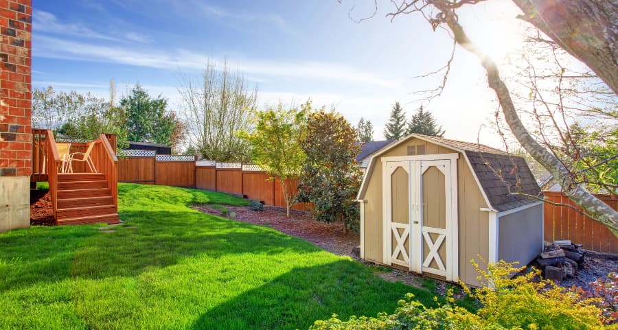 Fenced backyard with storage shed in Toledo